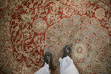 Worn-to-the-knot-heads texture on a vintage Ahar carpet with red arabesques on a dusty blue field.