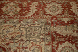 Worn pile on a vintage Ahar carpet showing its ruby red and beige serrated leaf border.