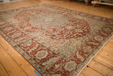 Distressed vintage Ahar carpet from a low perspective, showing its soft wear and scalloped medallion.