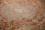 Low, worn pile over the Ahar carpet's dusty blue medallion and red scrolling arabesques.