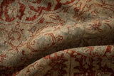 Soft, low-pile texture of a distressed Persian carpet with muted red and dusty blue hues.