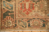 Oversize roundel and blossom-filled panels on a distressed vintage Persian Bakhtiari rug border.
