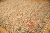 Angled view of a distressed Bakhtiari rug showing the panelled design and textured, low-pile weave.