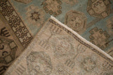 Corner detail of a distressed Hamadan runner showing the side selvage and hand-knotted back.