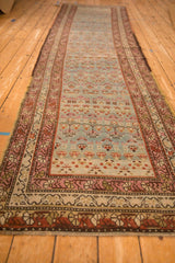 Low angle perspective showing the distressed Karabagh runner's full length and floral design.