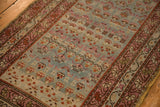 Meandering vine and blossom border in raspberry tones on a vintage Karabagh runner.