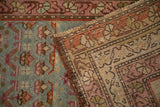 A corner of the vintage Karabagh rug showing the hand-knotted back and teal pile.
