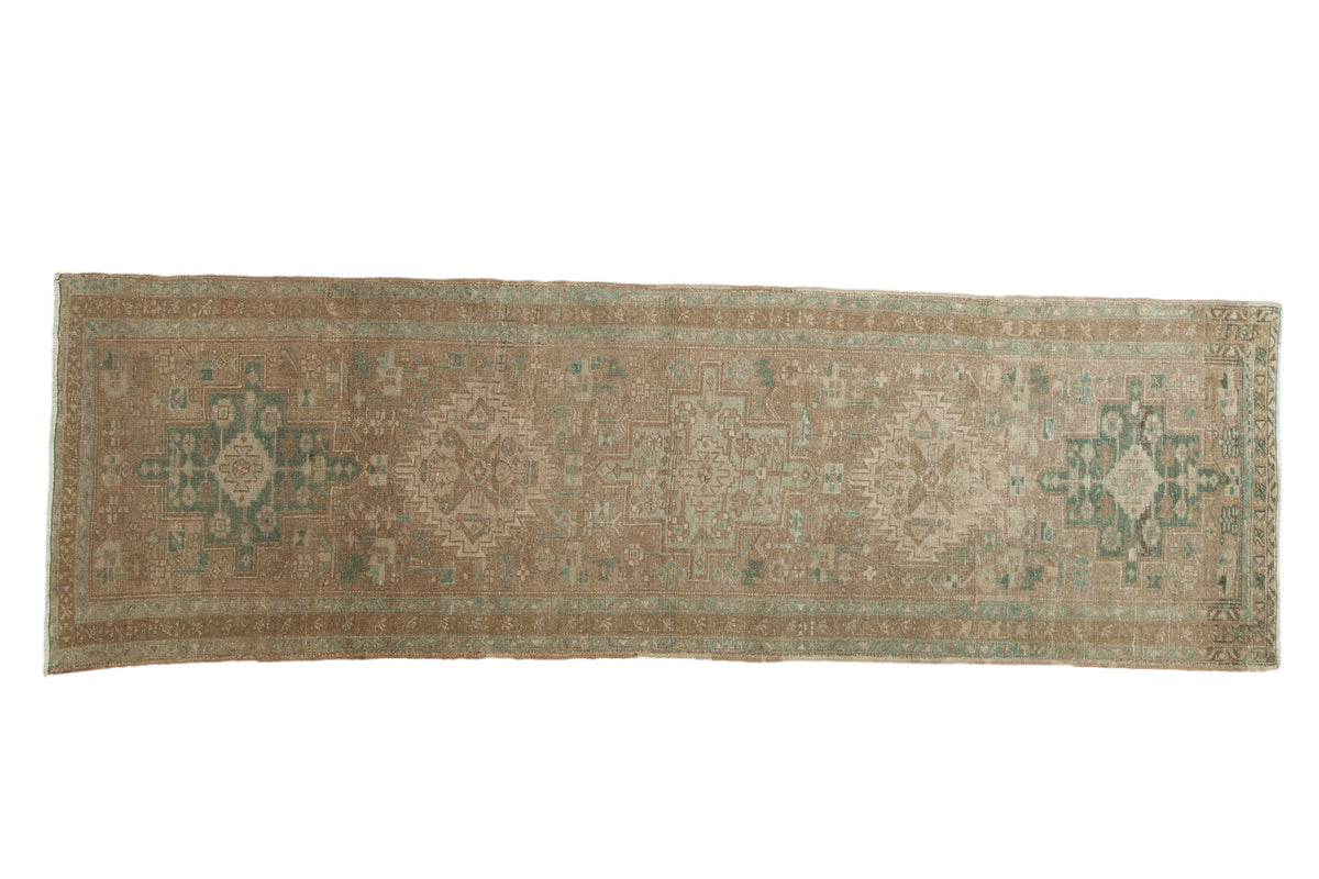 Vintage distressed Heriz rug runner with geometric center medallions in sandy beige and dusty seafoam green.
