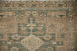 Worn hand-knotted pile showing the triple border of a vintage Heriz runner in sand and seafoam.