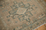 Even, low-pile wear on a distressed Heriz runner showing its sandy, hand-knotted texture.