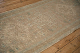 Even wear across the knot heads and low pile texture of a distressed Heriz runner.