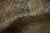 Evenly worn, low-pile texture of a hand-knotted vintage Heriz rug in beige and seafoam tones.
