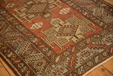 Geometric medallions with checkered designs and serrated leaf border on a distressed Heriz runner.