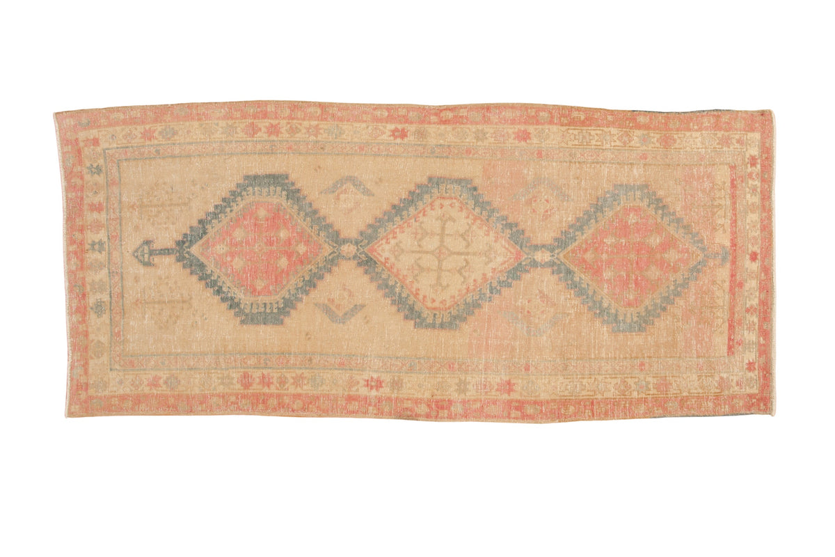 Vintage distressed Persian Serab runner with three interconnected geometric medallions in blush, sky blue, and sand.