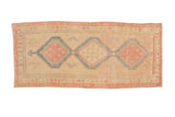 Vintage distressed Persian Serab runner with three interconnected geometric medallions in blush, sky blue, and sand.