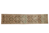 Antique distressed Karabagh runner with geometric diamond medallions in brown, sand, and dusty teal.