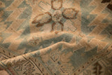 Close view of the antique Karabagh rug's low-worn pile and visible hand-knotted texture.