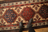 Geometric medallions and a reciprocating pawn border on a vintage hand-knotted Serab runner.