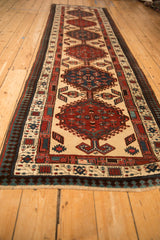 Angled view down the length of a vintage Serab runner, showing its repeating column of geometric medallions.