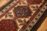 Angled view of a sapphire blue medallion and reciprocating pawn border on a vintage Serab runner.