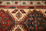 Geometric pawn border and hook and latch motifs in red, blue, and sand.