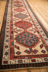 Angled view of a vintage Serab runner, showing the geometric pawn border and central medallions.