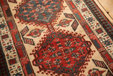 A vintage Serab rug's geometric medallions, hook and latch motifs, and detailed pawn border.