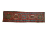Vintage Persian Karaja runner with a column of geometric medallions in red, sky blue, and green.