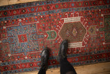 Overhead view of the geometric pinwheel medallions on a vintage Karaja runner in cherry red and sky blue.