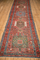 A column of pinwheel and diamond medallions runs the length of this vintage Karaja rug.