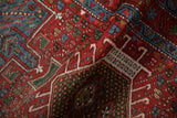 Folded detail showing the texture and geometric diamond guls of a hand-knotted Karaja rug.