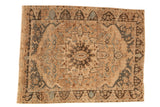 Vintage distressed Bakhtiari carpet with a starburst medallion and dragon border in sand, blue, and charcoal.