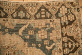 Distressed texture on the dragon border of a Bakhtiari carpet in charcoal, sand, and powder blue.