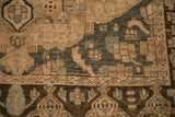 Even wear shows the knot heads and stylized border on a distressed Persian Bakhtiari rug.
