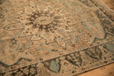 Evenly worn texture of a distressed Bakhtiari rug showing a charcoal and powder blue starburst medallion.