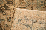 The hand-knotted foundation of a vintage Bakhtiari carpet, with its low, distressed pile visible.