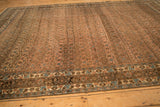 Angled view of the distressed Bijar carpet showing the worn texture and allover Herati pattern.