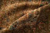 Angled view showing the turtle samovar border on a distressed, hand-knotted Bijar carpet.