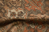 A fold reveals the supple texture and low, even pile of the distressed rug.