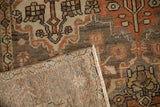 Corner of a vintage Bakhtiari rug folded over to display its tight back weave and wool pile.