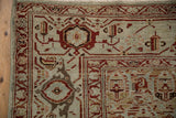 Corner of a distressed Persian rug with turtle samovar and meandering vine border motifs.