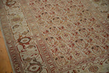 Angled view of a vintage Persian rug's main turtle samovar border and evenly worn pile.