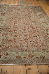 Low perspective view emphasizing the repeating boteh design and texture of a vintage Malayer rug.