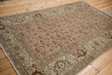 Distressed Malayer rug from an angle, showcasing the texture of its allover boteh design.