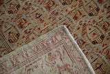 Corner detail of a distressed Malayer rug folded back to display its hand-knotted foundation.