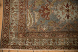 Vintage Distressed Malayer rug corner, intricate madder red and dusty teal borders, worn texture.