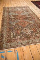 Muted dusty teal and madder red floral motifs with abrash on a vintage Malayer rug.