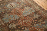Malayer rug with worn diamond and floral motifs in madder red, dusty teal, and charcoal.