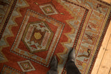 Hexagonal medallion and geometric animal border of a distressed Northwest Persian runner.
