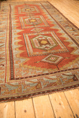 Low angle view of the distressed Persian runner's geometric and animal motifs.